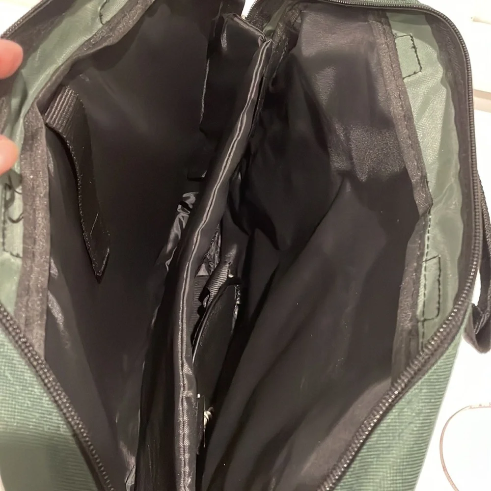 Dark green canvas briefcase with laptop sleeve and multiple pockets. NWT